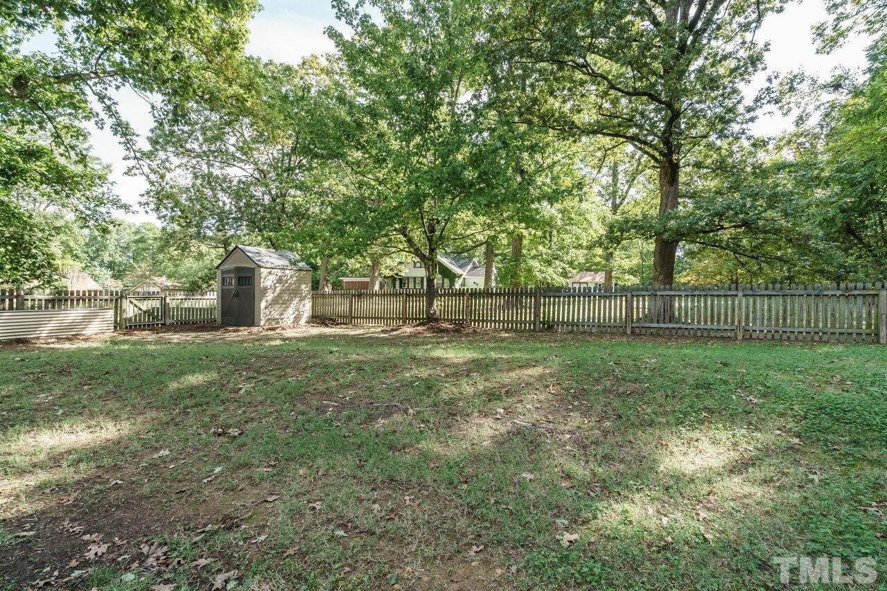 4202 Holt School Road Durham, NC 27704 - Photo 23 of 27 a view of a yard with a large tree
