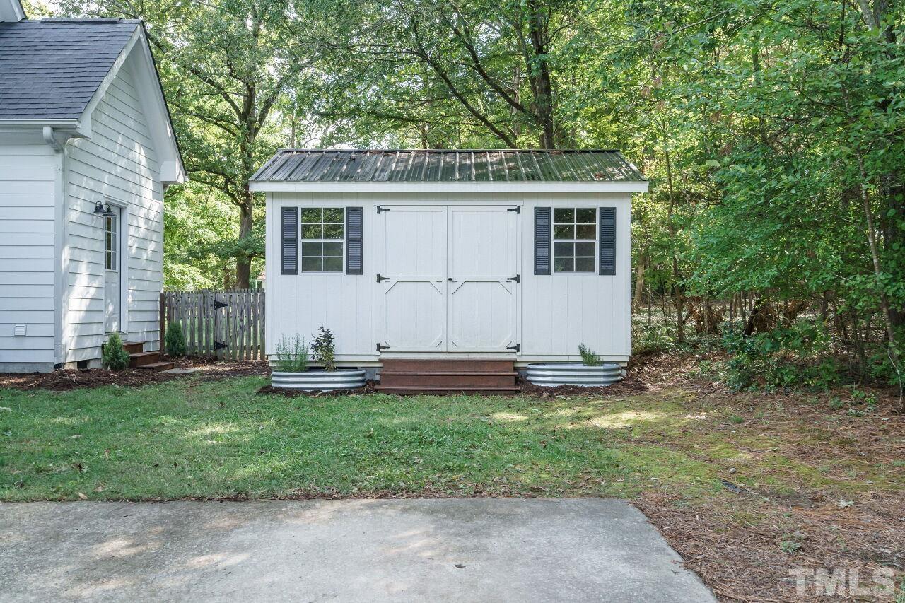 4202 Holt School Road Durham, NC 27704 - Photo 25 of 27 a view of a house with a yard and sitting area