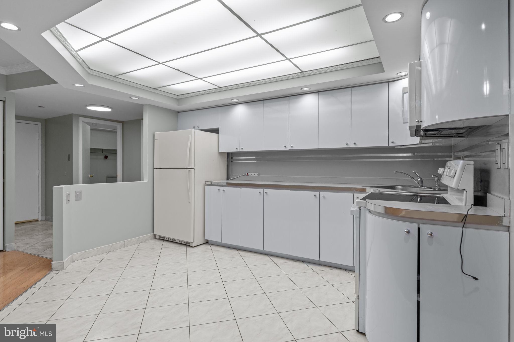 2131 Welsh Road, Unit 208 Philadelphia, PA 19115 - Photo 11 of 21 a kitchen with cabinets and a stove top oven
