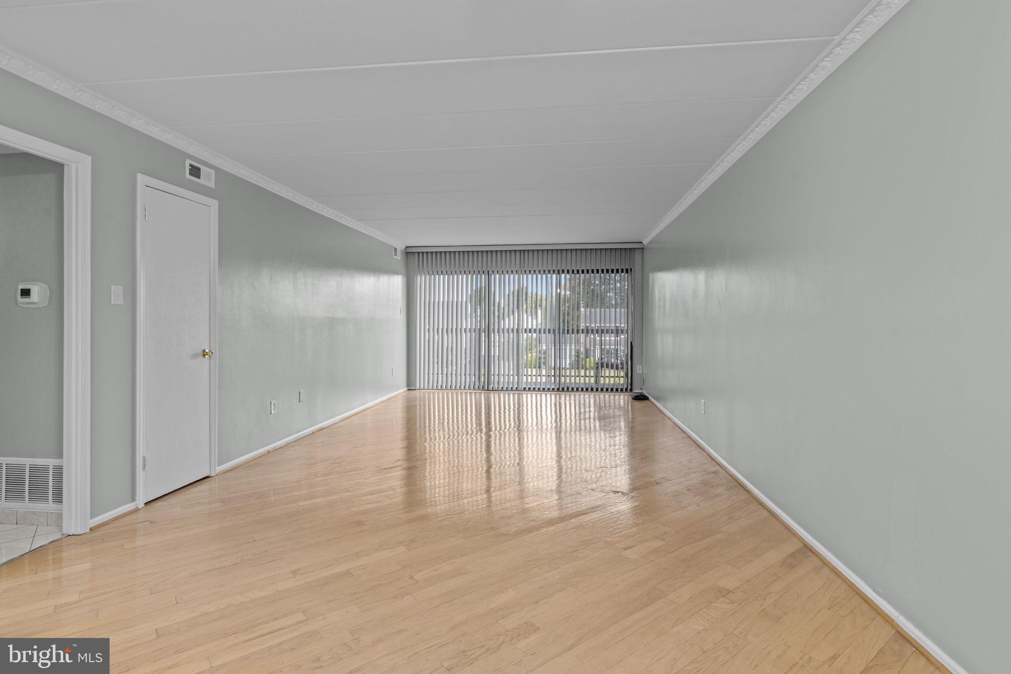 2131 Welsh Road, Unit 208 Philadelphia, PA 19115 - Photo 15 of 21 a view of an empty room with wooden floor and a window