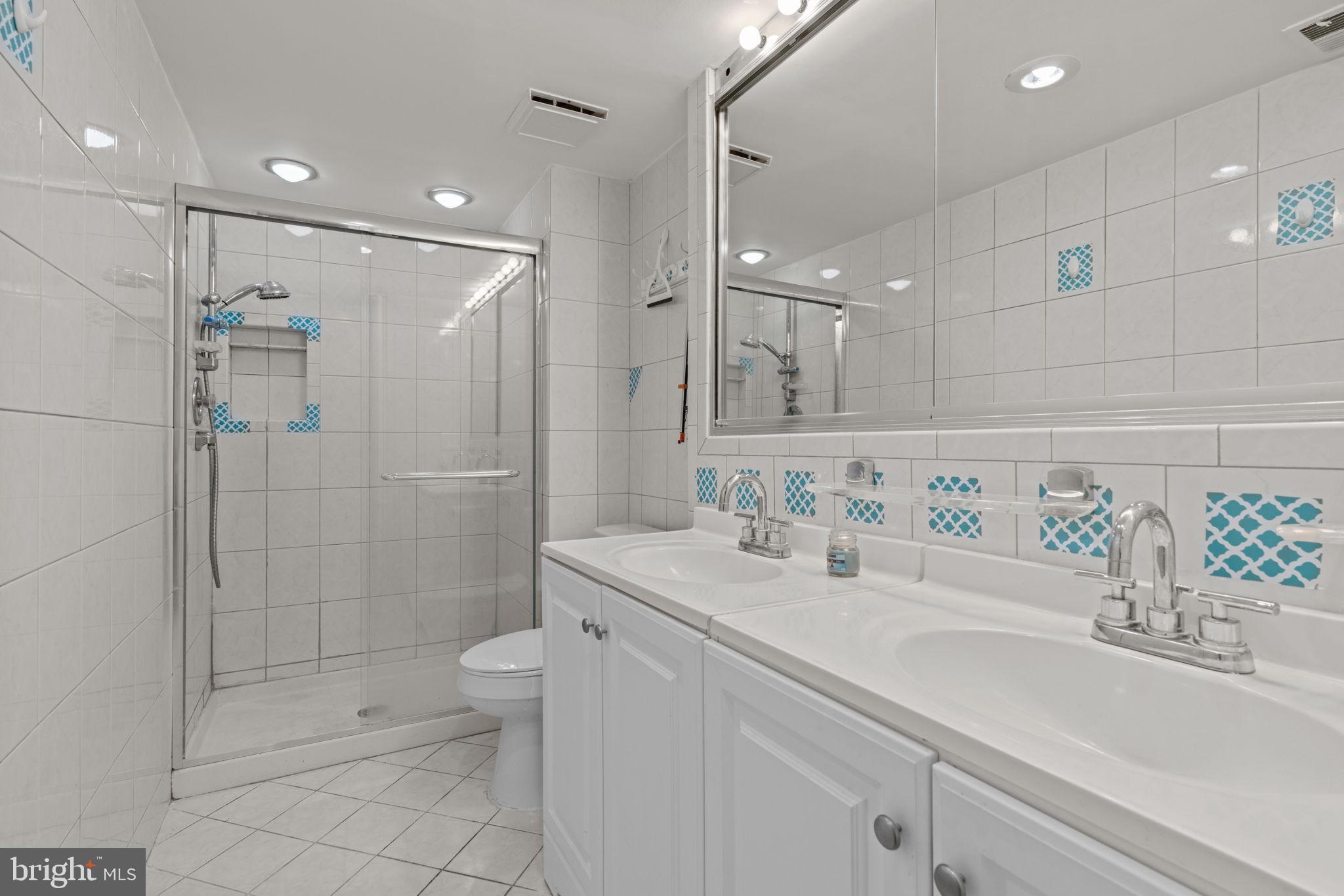 2131 Welsh Road, Unit 208 Philadelphia, PA 19115 - Photo 9 of 21 a bathroom with a sink a toilet and shower