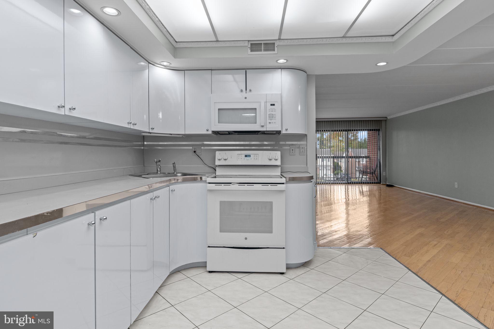 2131 Welsh Road, Unit 208 Philadelphia, PA 19115 - Photo 10 of 21 a kitchen with stainless steel appliances granite countertop a sink a stove and a refrigerator