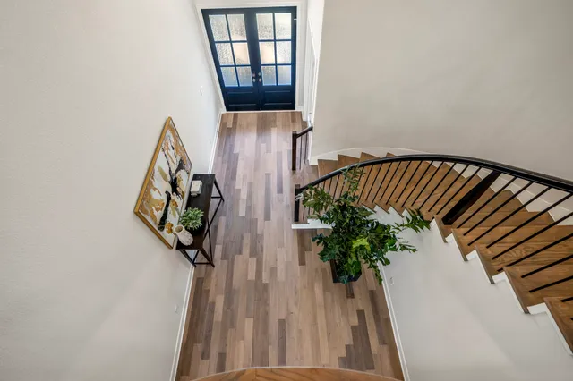 a view of balcony with wooden floor and a potted plant