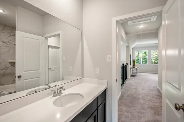 a en suite bathroom with a sink and mirror