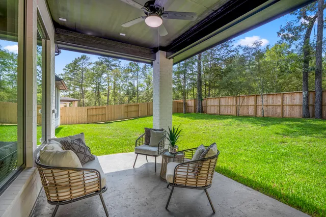 a view of a porch with furniture and garden