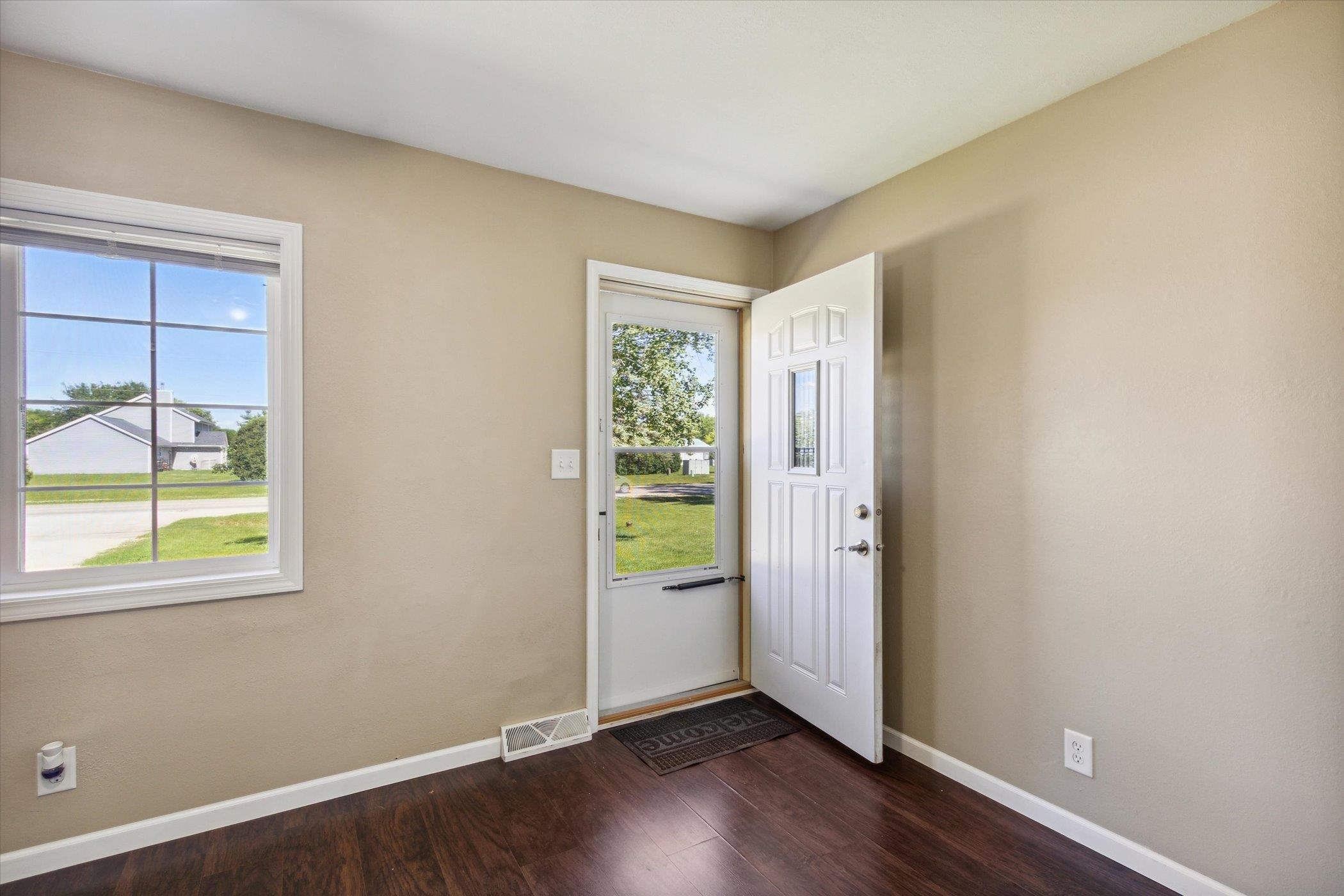 12570 Dorr Road Rockton, IL 61072 - Photo 6 of 43 an empty room with wooden floor and windows