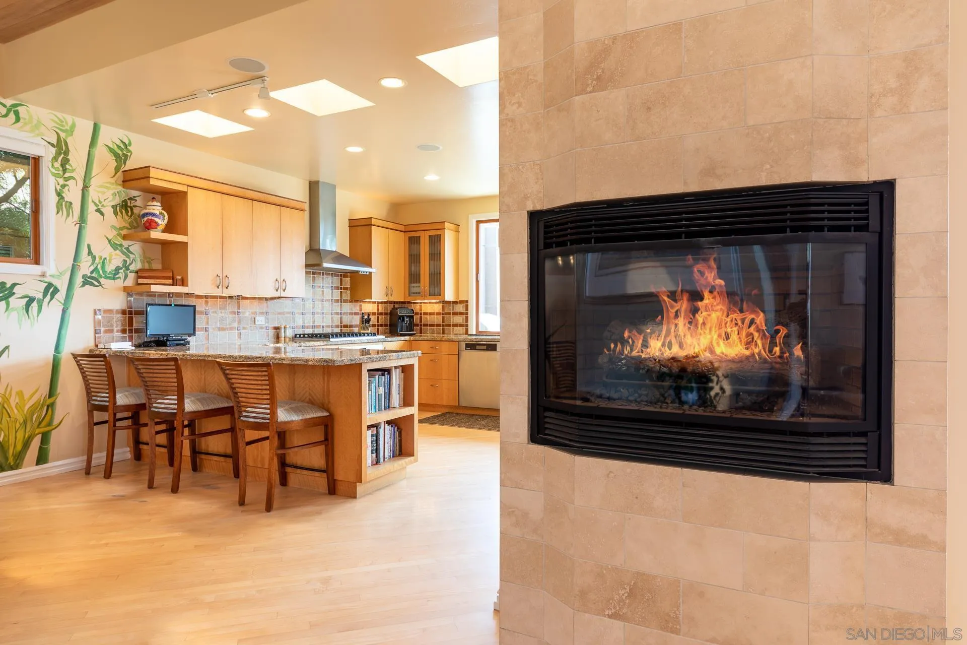 13748 Pine Needles Drive Del Mar, CA 92014 - Photo 14 of 49 a living room with stainless steel appliances furniture a fireplace and a flat screen tv
