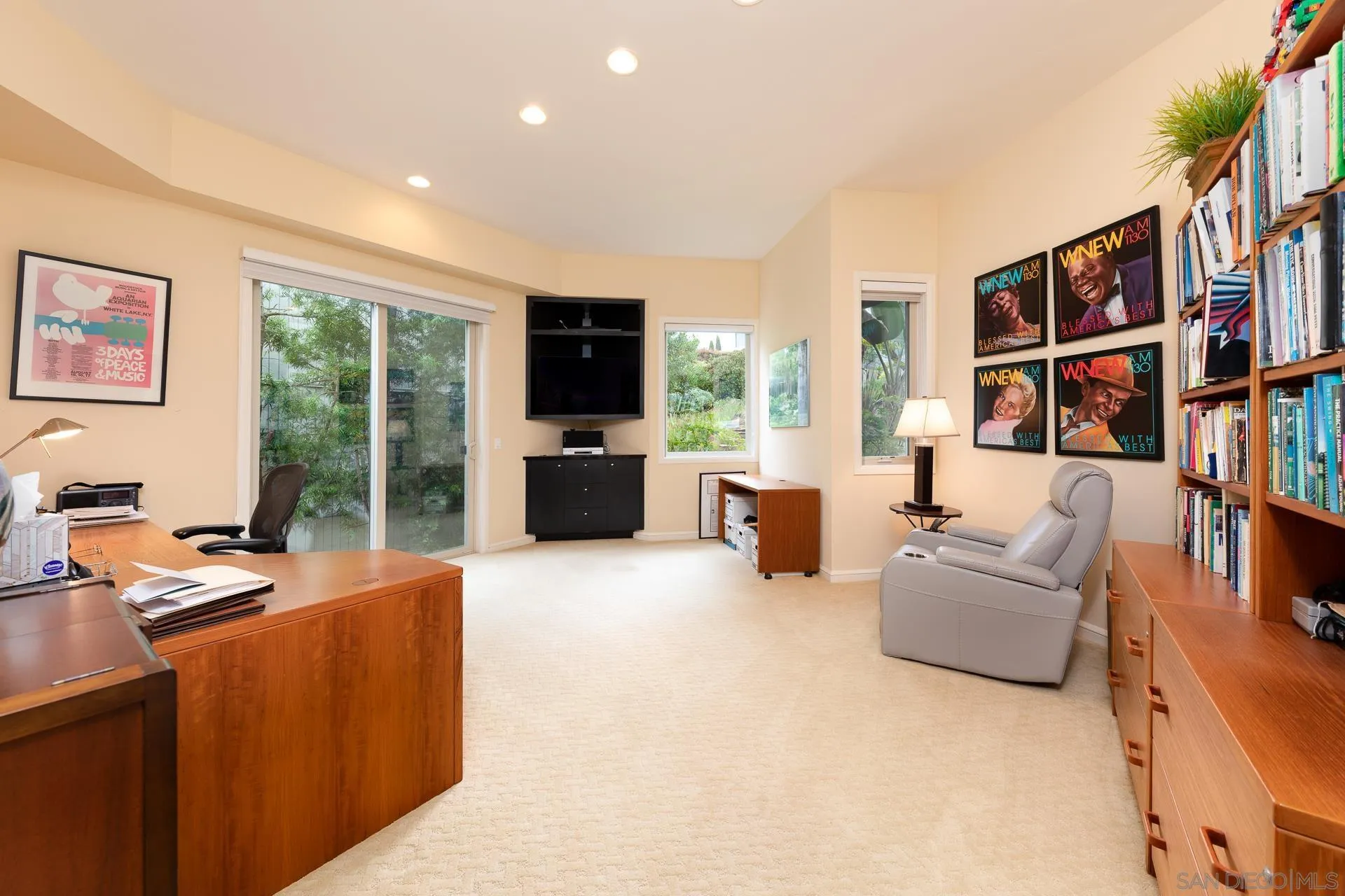 13748 Pine Needles Drive Del Mar, CA 92014 - Photo 28 of 49 a living room with furniture a bookshelf and a flat screen tv