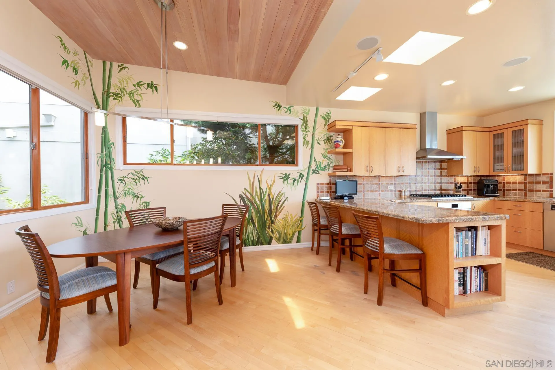 13748 Pine Needles Drive Del Mar, CA 92014 - Photo 8 of 49 a open dining room with stainless steel appliances a dining table wooden floor and a large window
