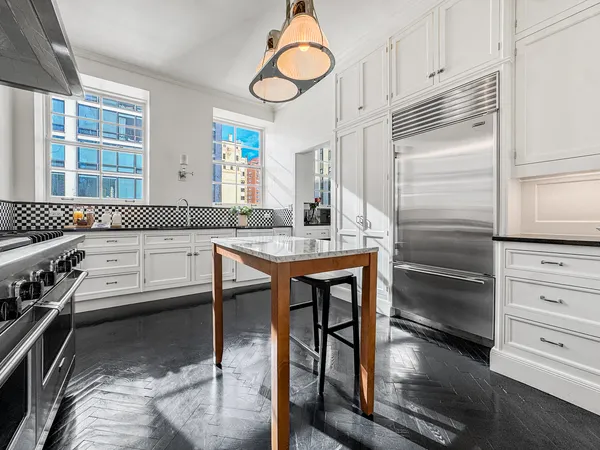 a kitchen with stainless steel appliances granite countertop a stove and a refrigerator