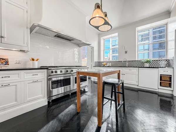 a kitchen with a table and chairs in it