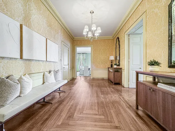 a living room with furniture and a chandelier