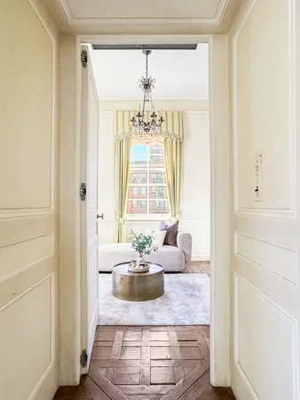 a living room with fireplace furniture and a rug