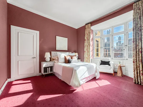 a bedroom with a bed and a couch