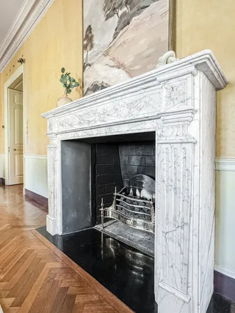 a living room with a table and windows