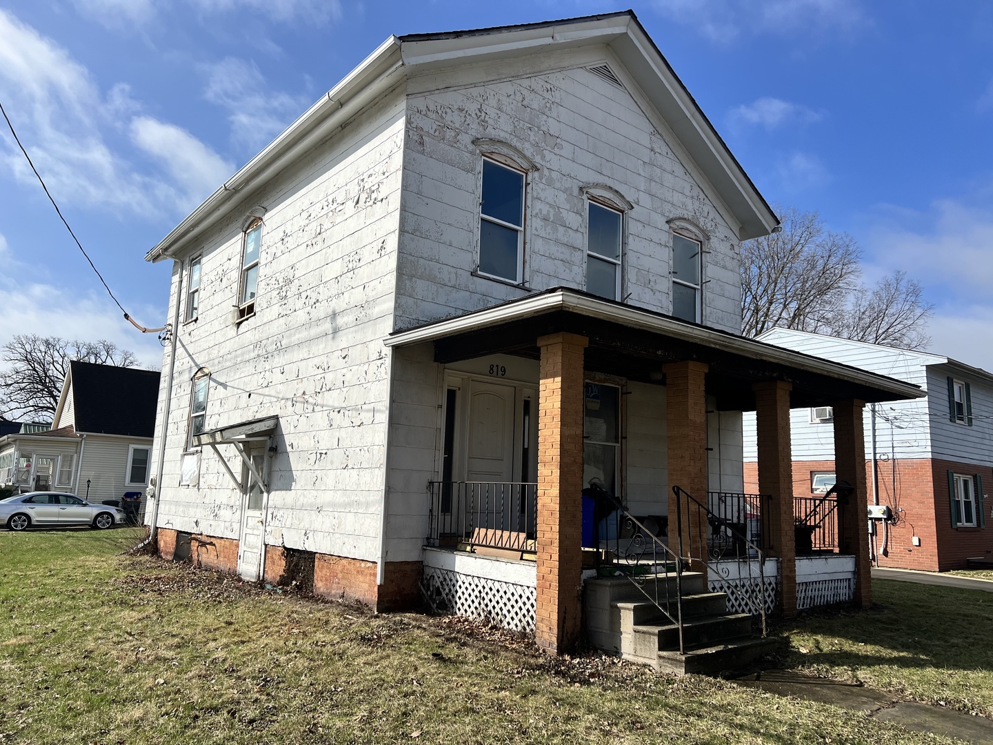 819 Bell Street Bloomington, IL 61701 - Photo 13 of 14 a front view of a house with barbeque grill and wooden fence