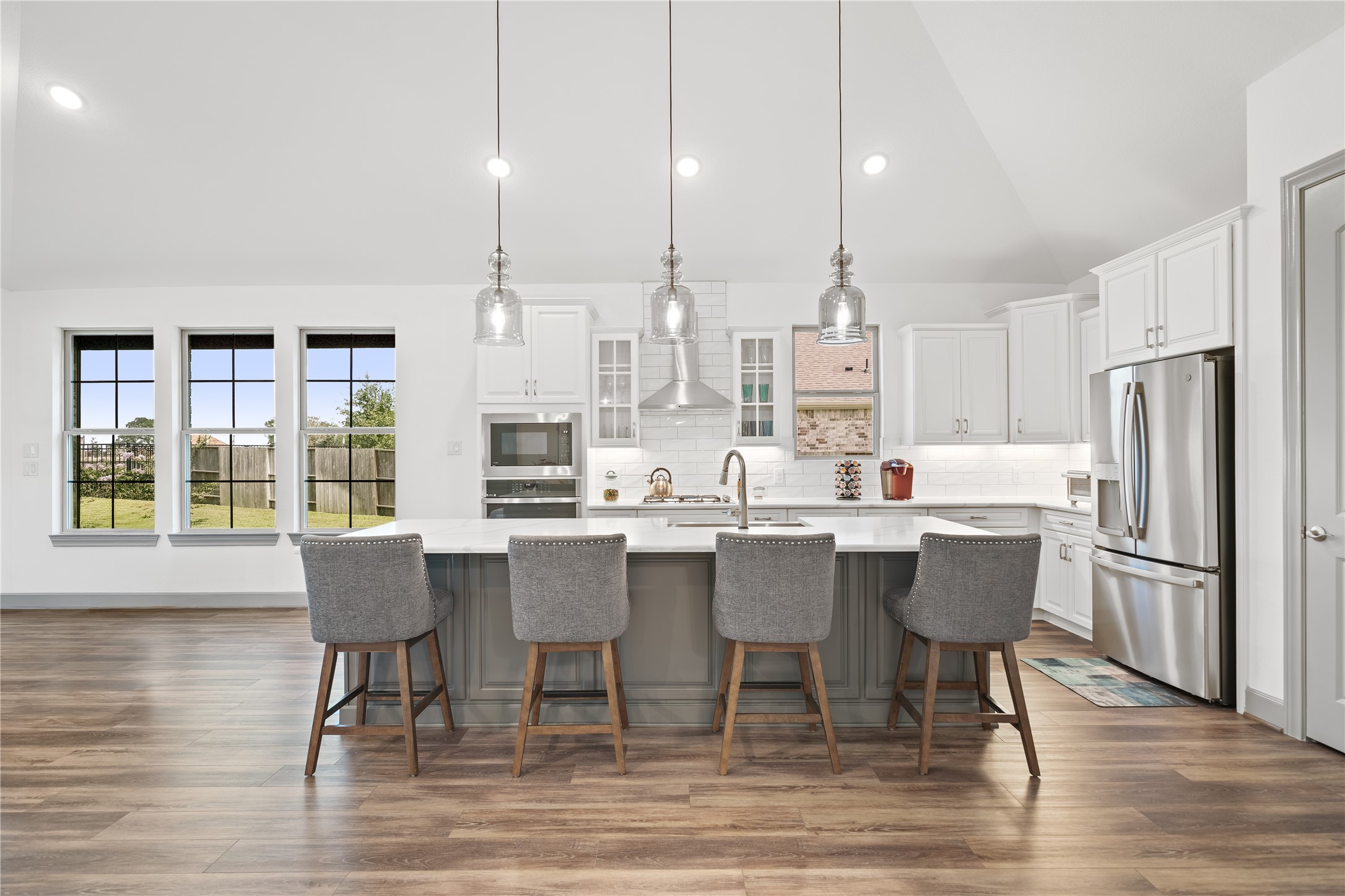 5739 Bobwhite Trail Manvel, TX 77578 - Photo 9 of 29 A large center island anchors the kitchen, offering generous prep space and casual seating. Crisp cabinetry, quartz countertops, and designer finishes give the space timeless appeal.