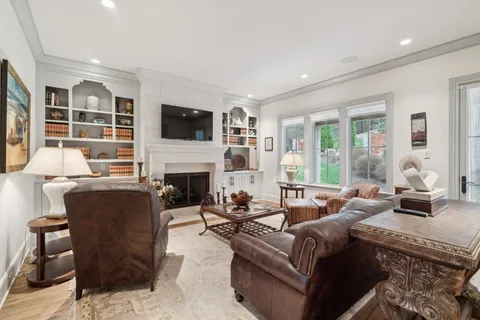 a living room with furniture fireplace and flat screen tv