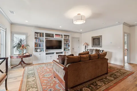 a bedroom with bed and a view of living room