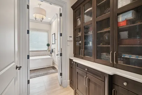 a front view of a house with a yard and potted plants