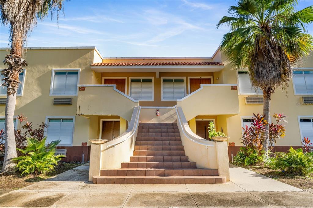 a front view of house with a garden