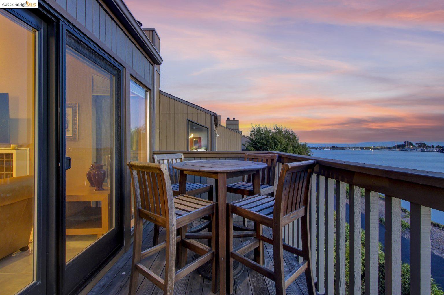 a view of a balcony with furniture and wooden floor