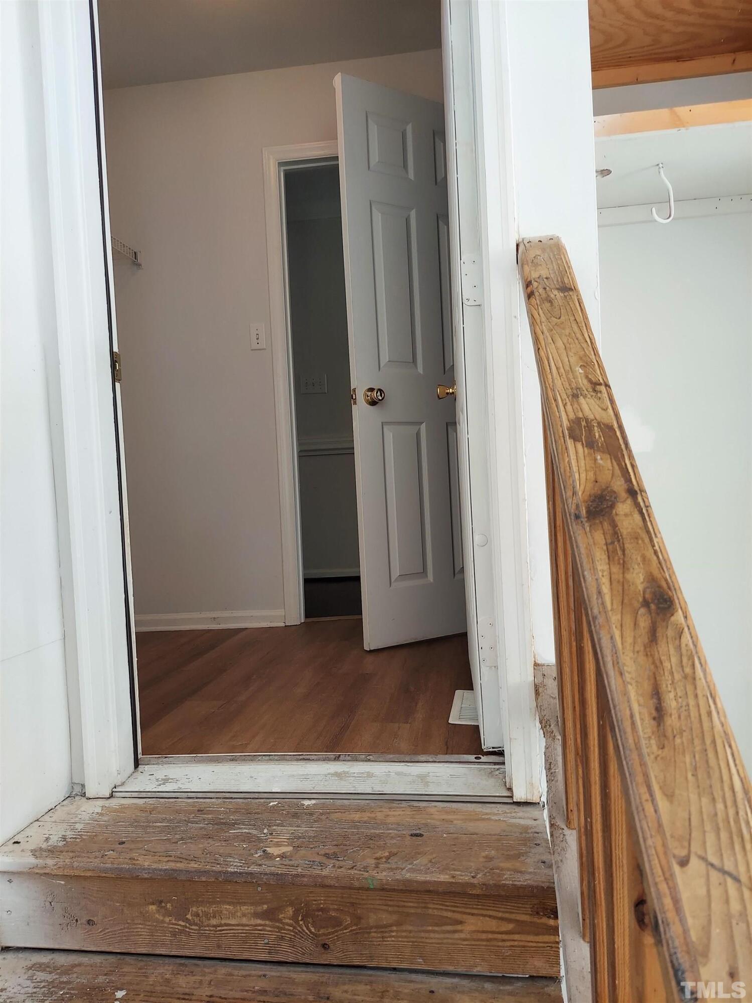 224 Crossfire Road Holly Springs, NC 27540 - Photo 34 of 43 a view of a hallway with wooden floor and staircase