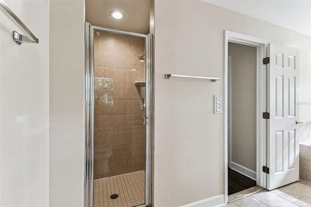 a bathroom with a glass shower door and a bathroom