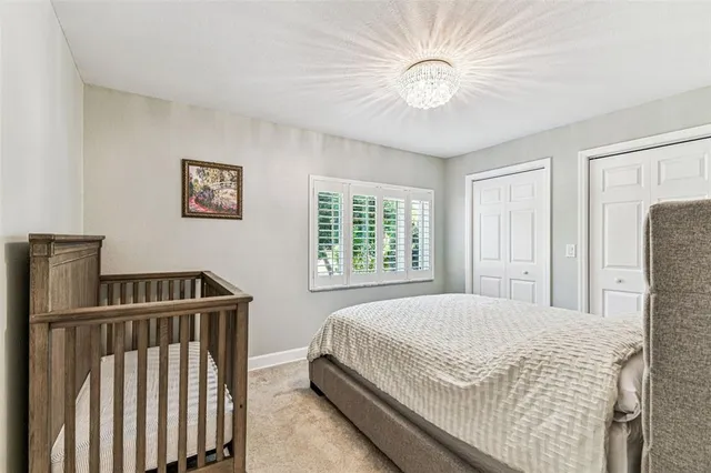 a bedroom with a bed and a chandelier