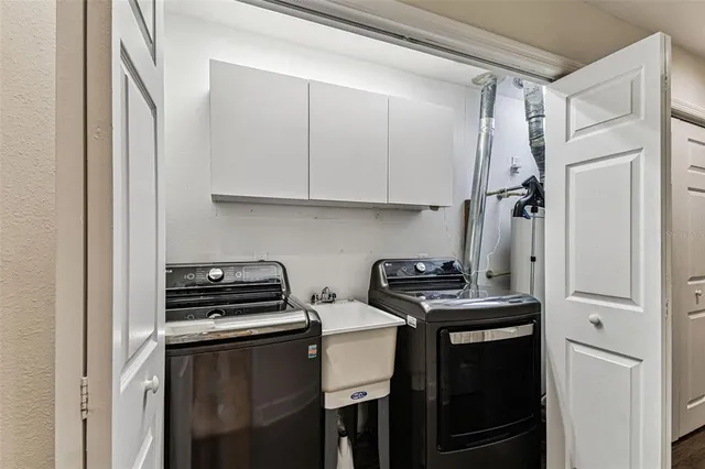 a view of a refrigerator and cabinets in a room