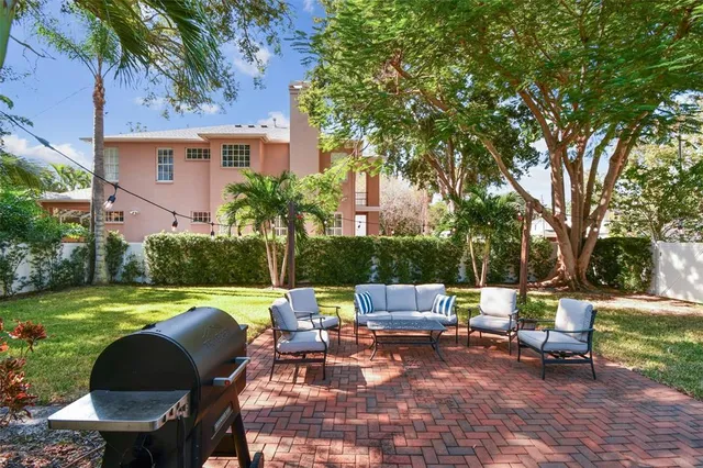 a view of a backyard with sitting area furniture and a fire pit