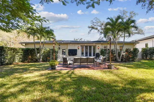 a view of a patio with a table and chairs under an umbrella