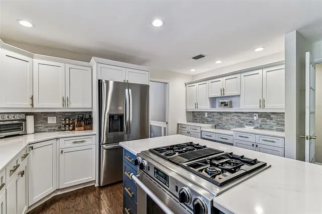 a kitchen with a stove and a refrigerator