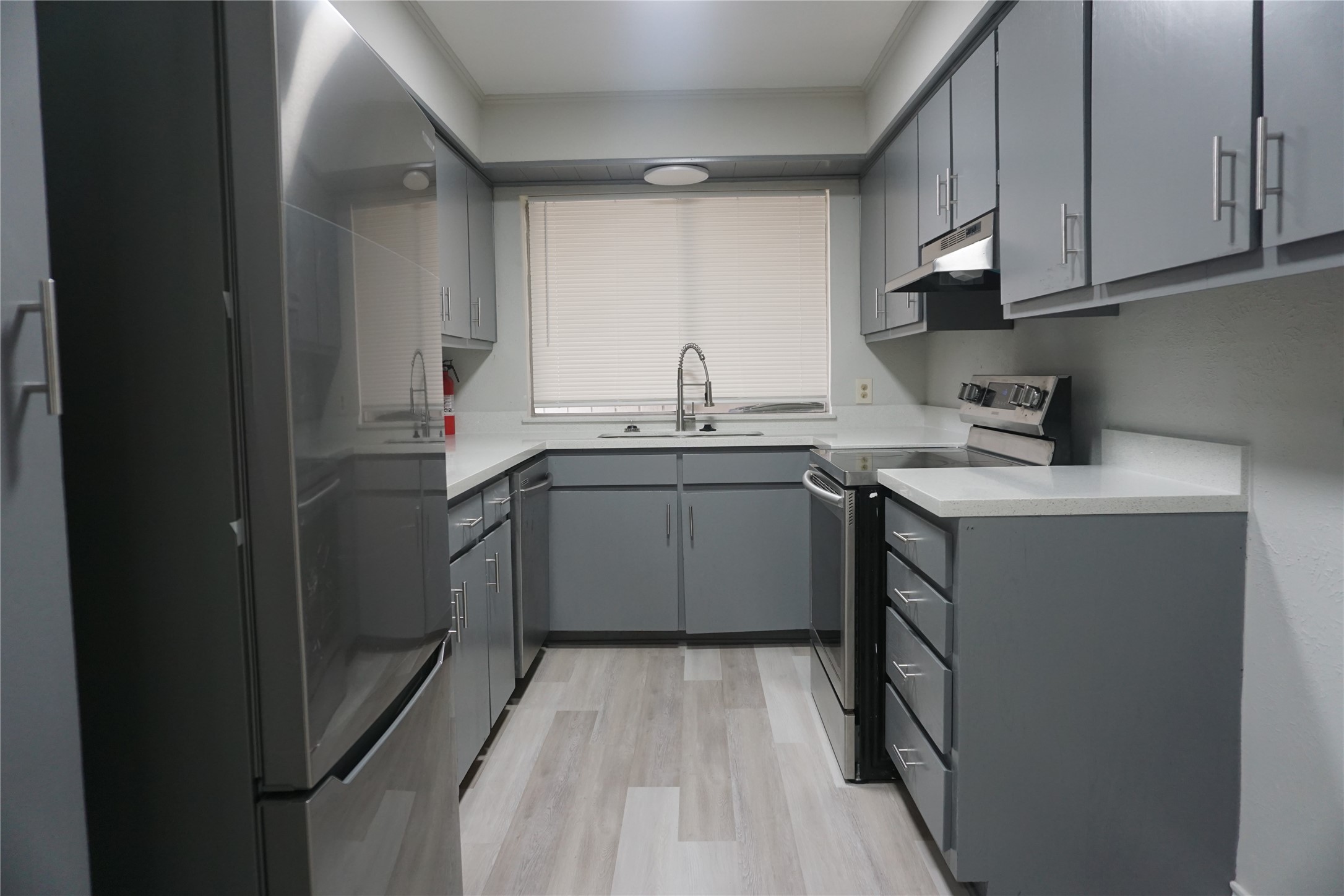 1913 Normal Park Drive, Unit B Huntsville, TX 77340 - Photo 11 of 29 a kitchen with a sink a stove cabinets and a window