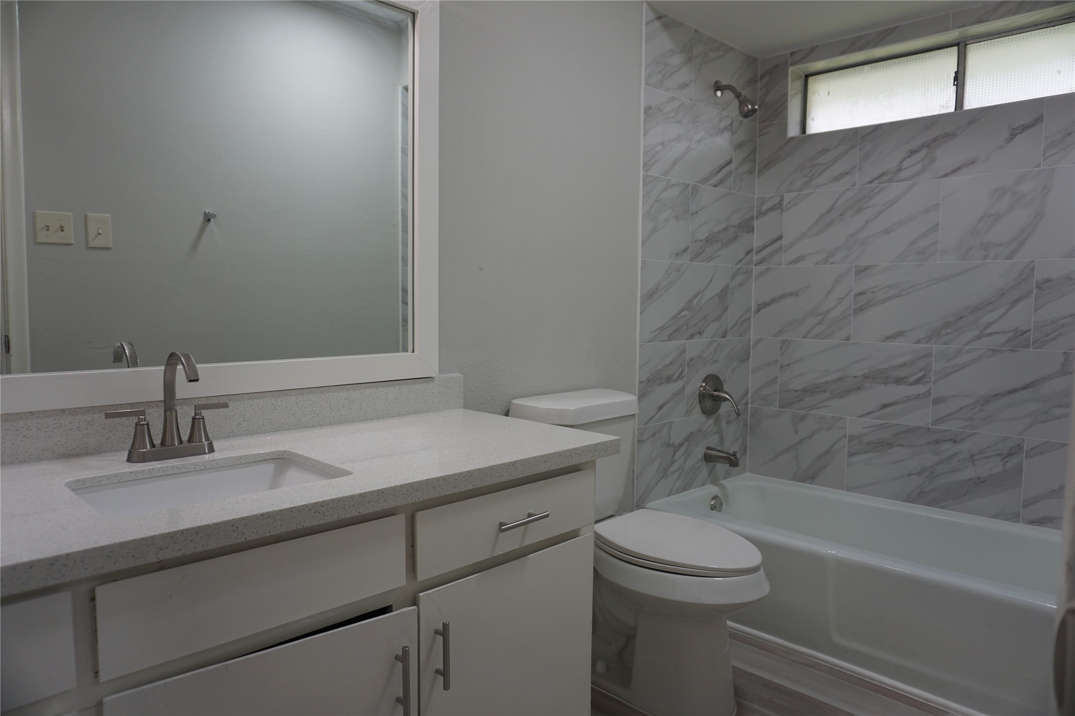 1913 Normal Park Drive, Unit B Huntsville, TX 77340 - Photo 16 of 29 a bathroom with a granite countertop sink toilet and shower