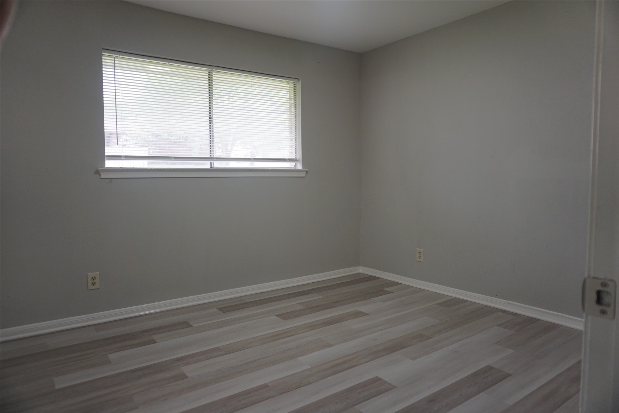 1913 Normal Park Drive, Unit B Huntsville, TX 77340 - Photo 18 of 29 wooden floor and window in an empty room