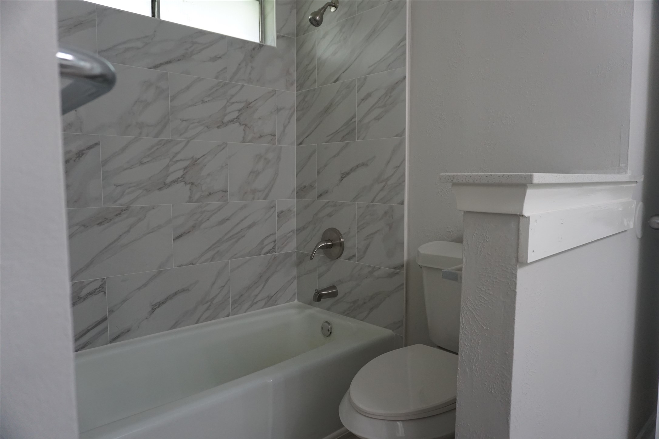 1913 Normal Park Drive, Unit B Huntsville, TX 77340 - Photo 22 of 29 a bathroom with a toilet and bathtub