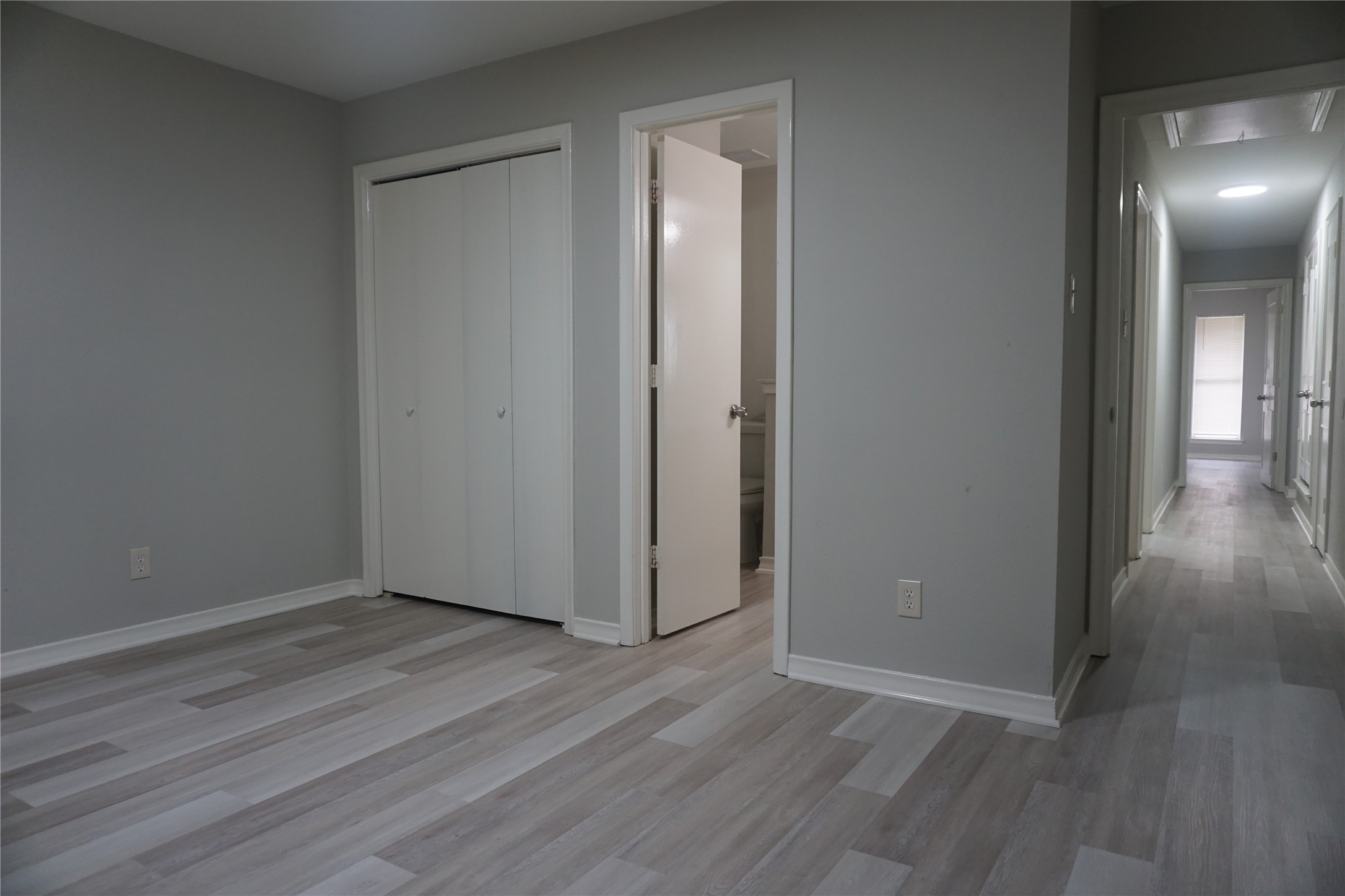 1913 Normal Park Drive, Unit B Huntsville, TX 77340 - Photo 24 of 29 a view of an empty room with wooden floor and a mirror