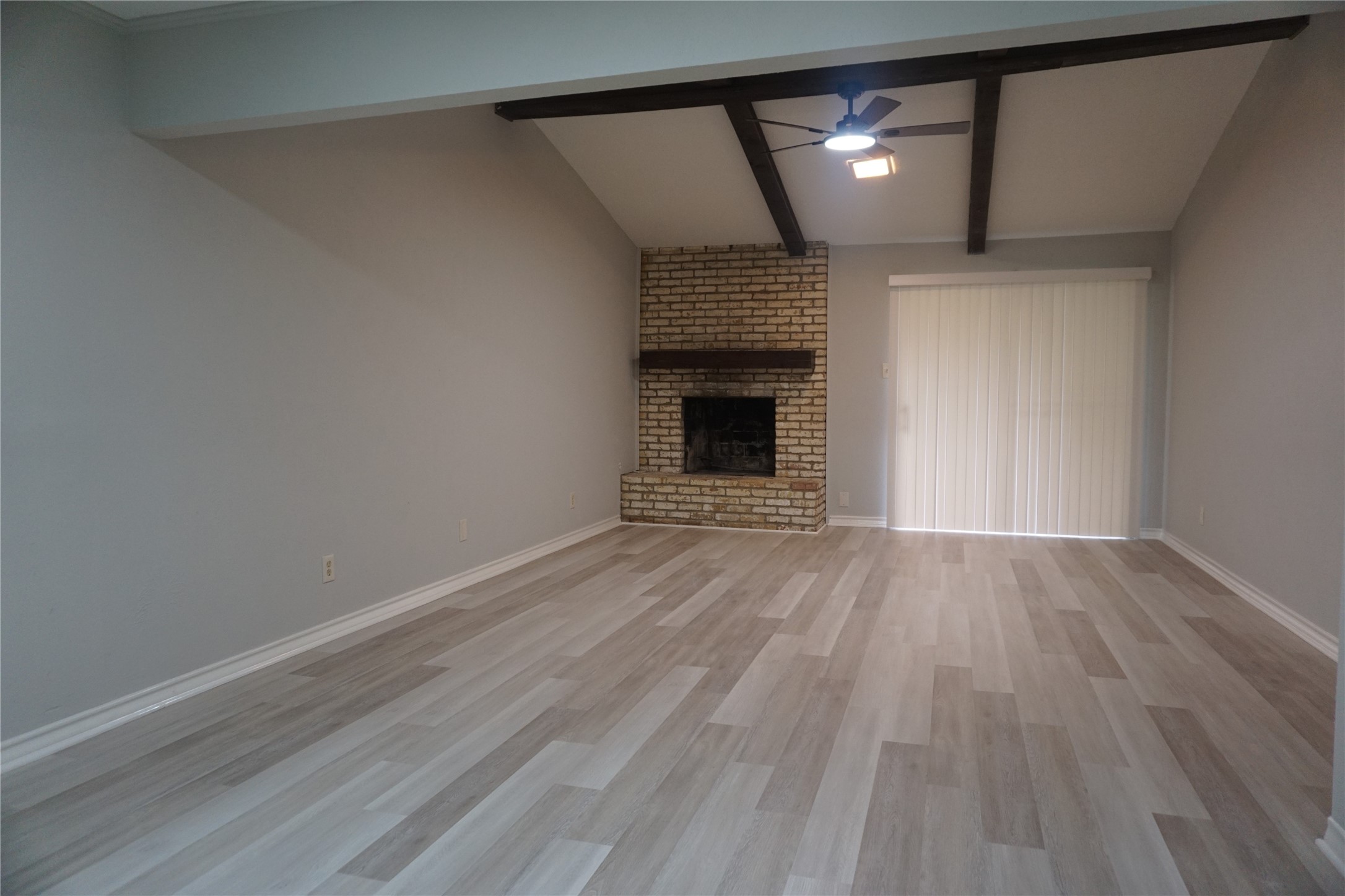 1913 Normal Park Drive, Unit B Huntsville, TX 77340 - Photo 6 of 29 a view of empty room with wooden floor and fireplace