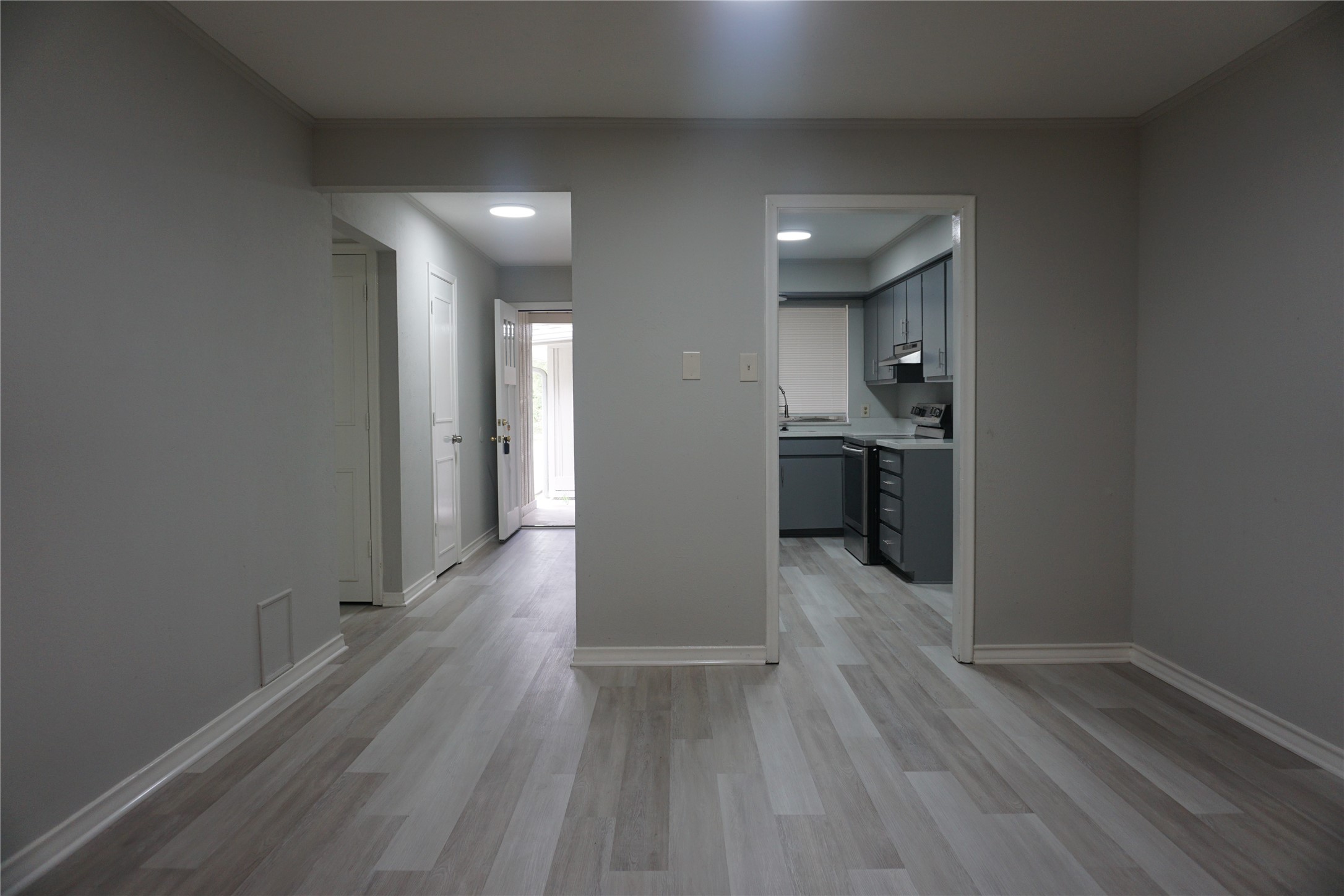 1913 Normal Park Drive, Unit B Huntsville, TX 77340 - Photo 10 of 29 a view of a big room with wooden floor and a kitchen