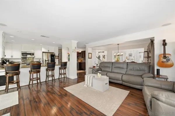 a kitchen with a dining table chairs sink and microwave