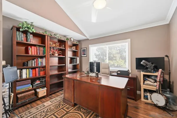 a bedroom with a bed and a tv on table