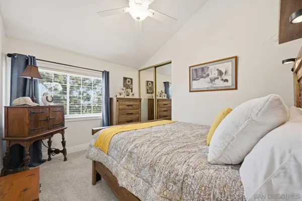 a bathroom with a sink vanity mirror and toilet