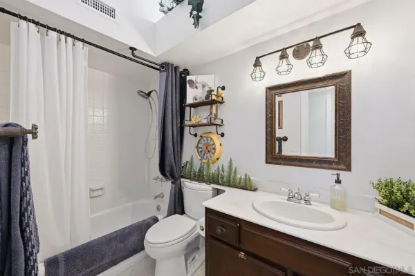 a living room with furniture a flat screen tv and a floor to ceiling window