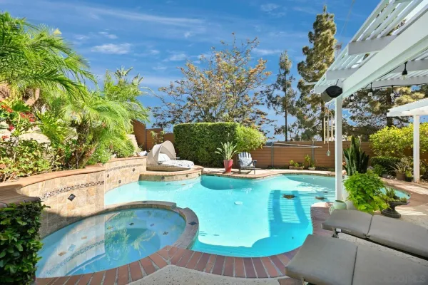 a view of a patio with a table chairs and a backyard