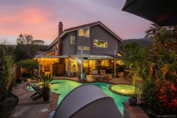 a view of a backyard with a table and chairs