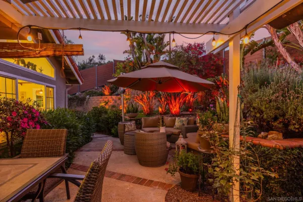 a view of an outdoor dining space with a table and chairs