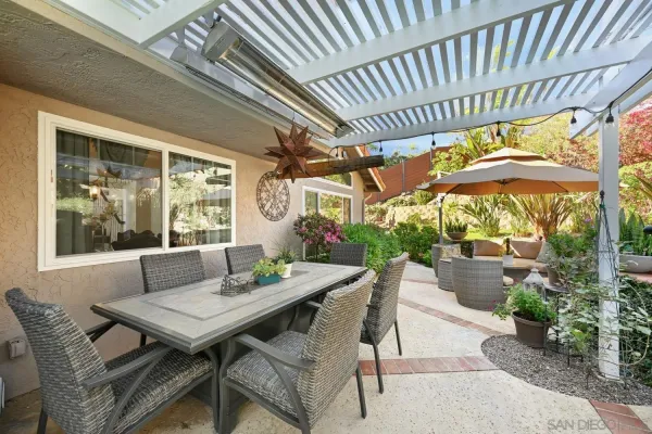 a view of backyard of house with seating space