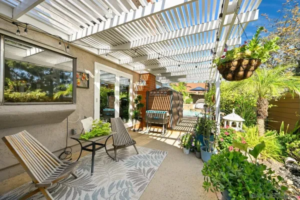 an aerial view of house with yard and mountain view in back
