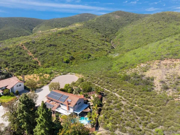 an aerial view of a house with a yard